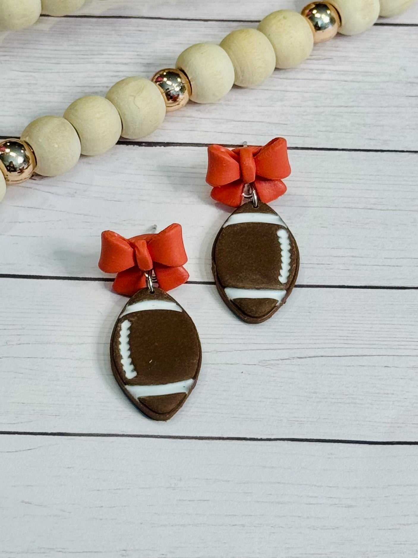 Orange Bow Stud Football Earrings